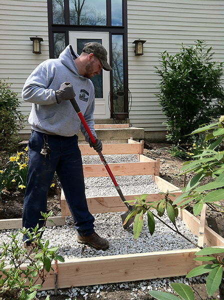worker building stairs outside home
