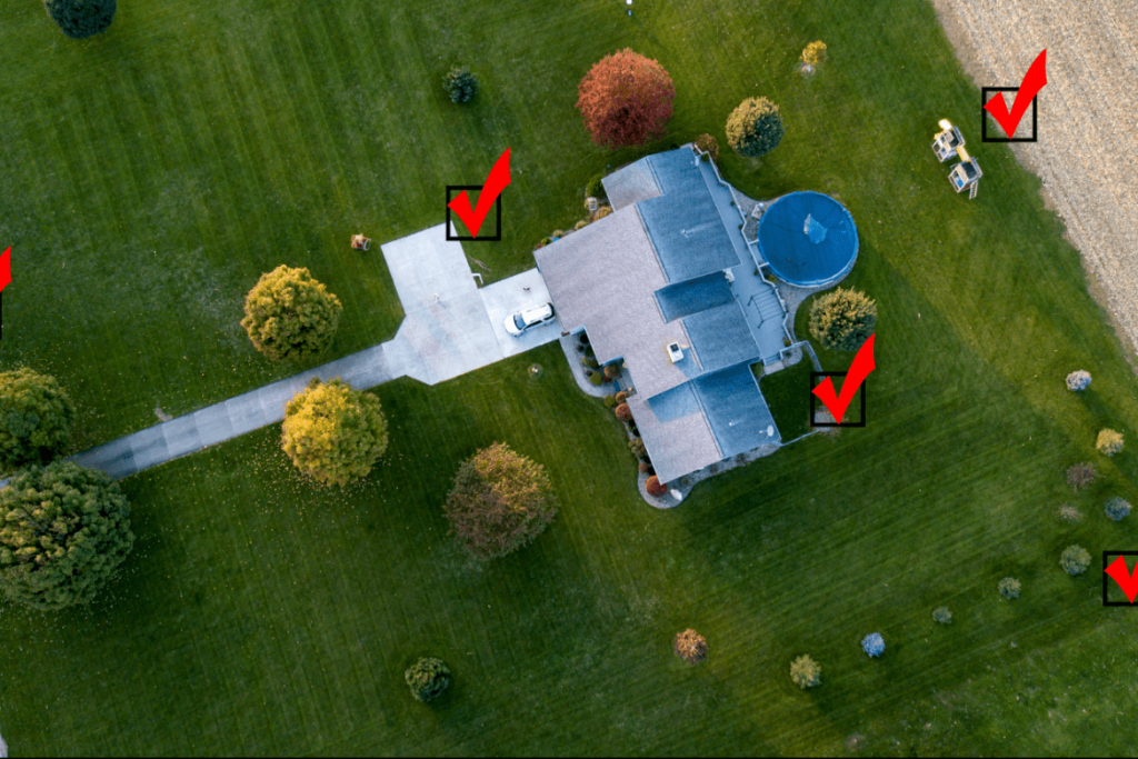 overhead view of house with red checkmarks surrounding it