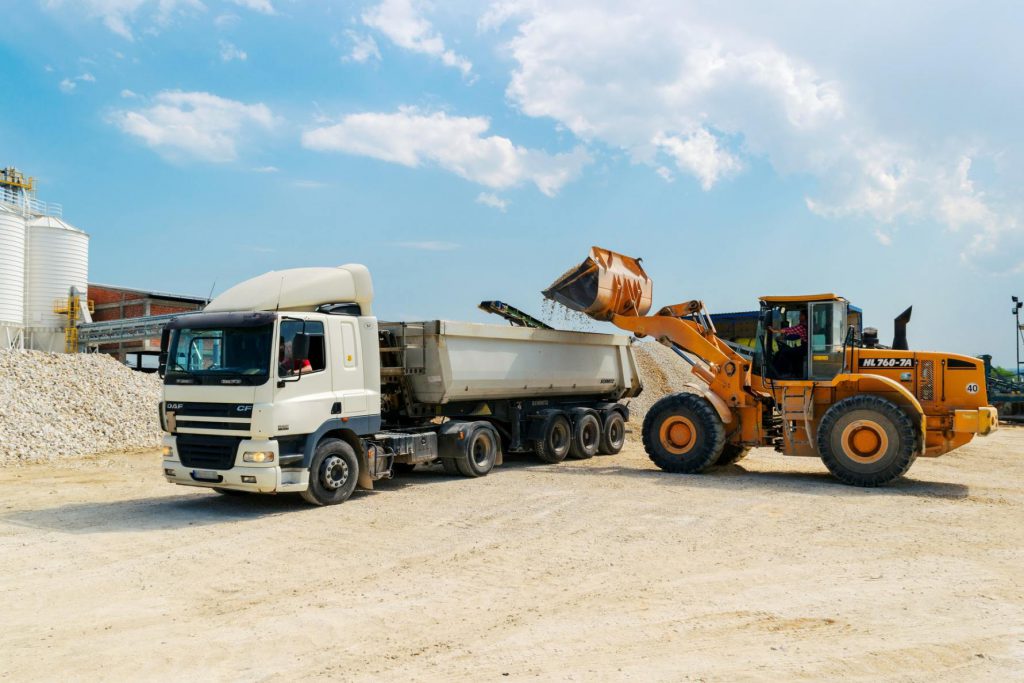 front end loader putting dirt into dump truck