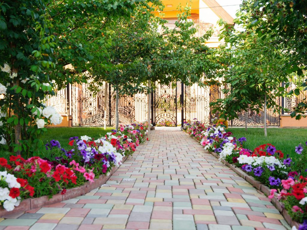 paver walkway flower beds on the sides