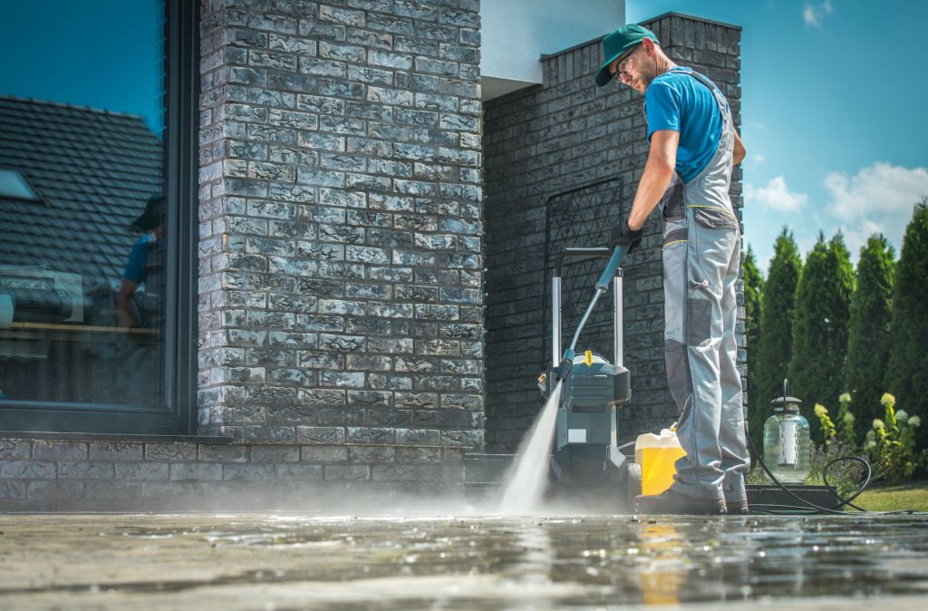 person power washing cement